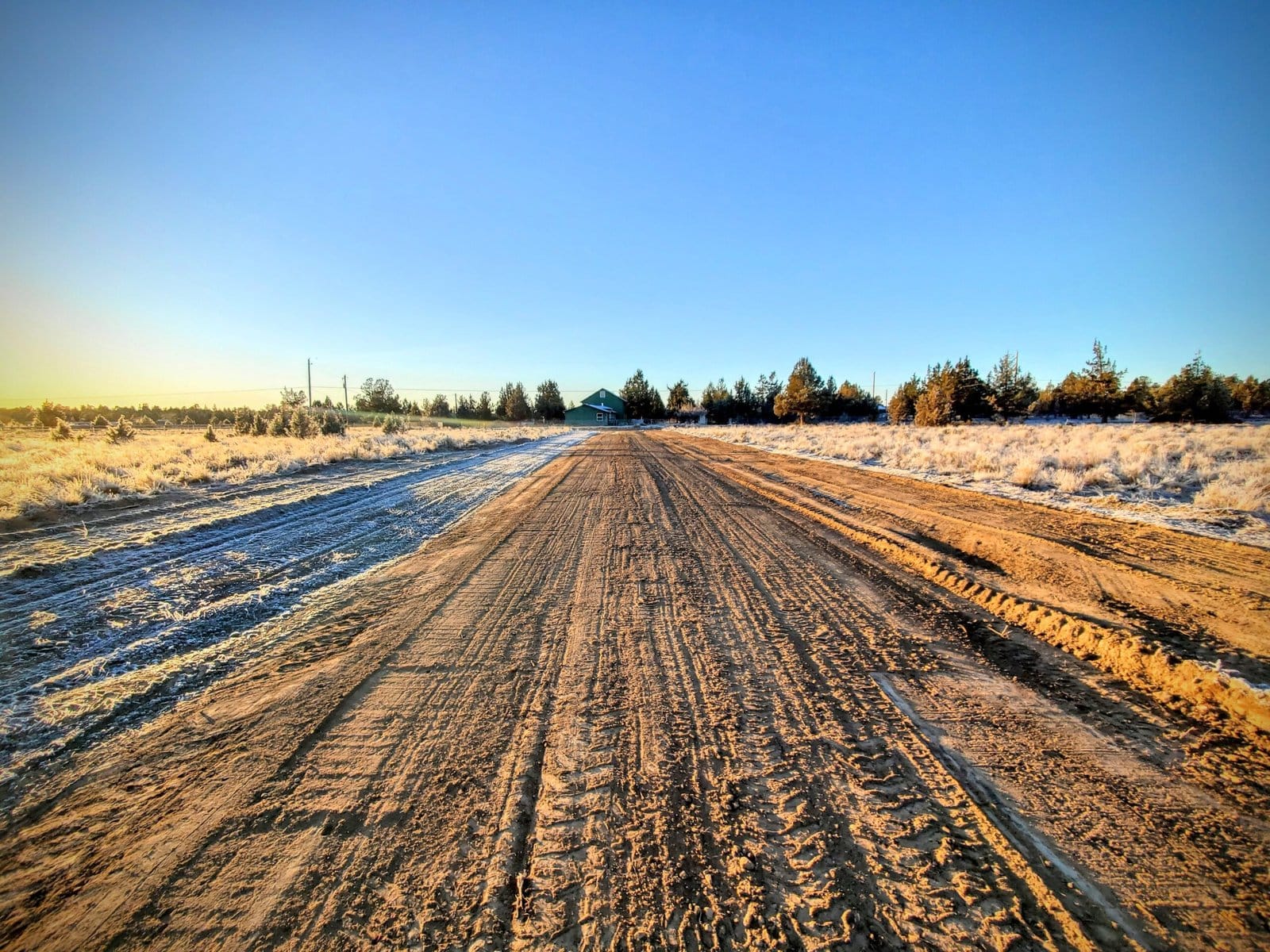 Gravel driveway approach where a rural driveway meets a county road